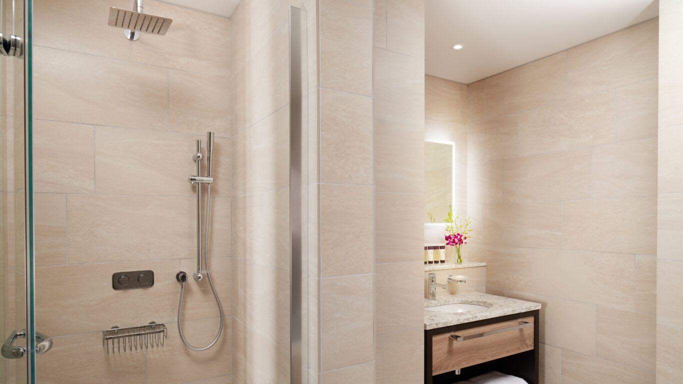 Modern bathroom with beige tiles, featuring a rainfall shower, chrome fixtures and a granite vanity with a sink